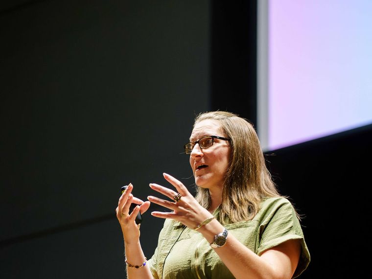 Lainie Hodges leading an exercise, demonstrating with her hands.